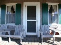 front door with adirondack chairs